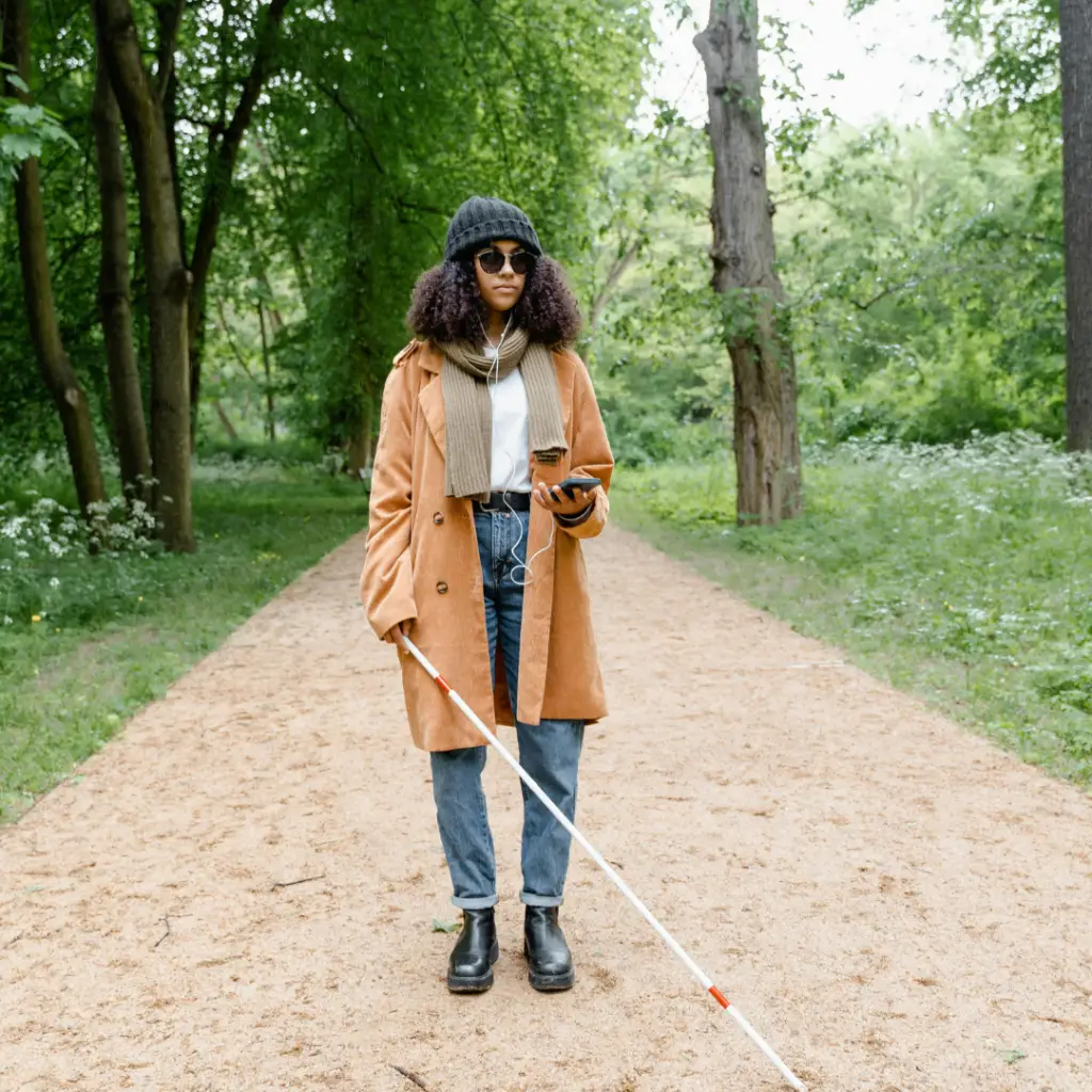 Blind young woman walking at a park